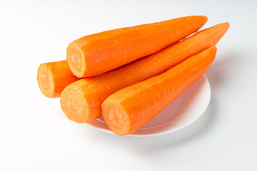 Peeled fresh carrots isolated on white background