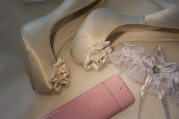 Wedding women's shoes and perfumes on the dress.