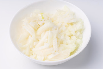 White onion, finely chopped in white plate