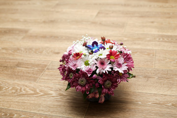 bouquet of spring and wild flowers. flowers stand on a wooden floor. macroshooting