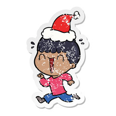 laughing distressed sticker cartoon of a man wearing santa hat