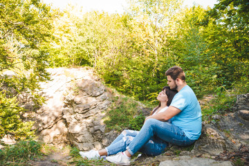 Naklejka na ściany i meble couple sitting and hugging in forest