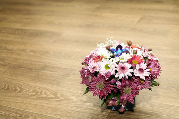 multi-colored camomiles and other spring flowers in a bouquet