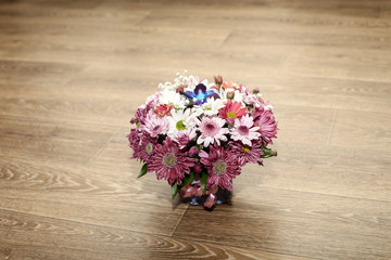 flowers in a bouquet stand on a wooden background