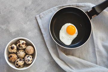 Quail egg fried in a pan. Fresh organic egg.