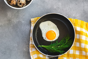 Quail egg fried in a pan. Fresh organic egg.