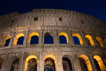 Obraz premium Night at the Great Roman Colosseum (Coliseum, Colosseo), also known as the Flavian Amphitheatre with lights & illumination.