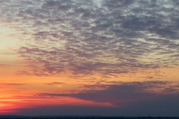 Fototapeta na wymiar Beautiful orange sunset background with dark clouds