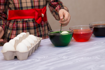 Happy easter. Little girl painter painted eggs. Kid preparing for Easter. Painted hand. Art and craft concept. Traditional spring holiday food