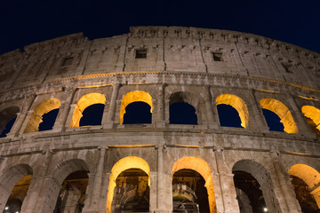 Naklejka premium Night at the Great Roman Colosseum (Coliseum, Colosseo), also known as the Flavian Amphitheatre with lights & illumination.