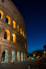Naklejka premium Night at the Great Roman Colosseum (Coliseum, Colosseo), also known as the Flavian Amphitheatre with lights & illumination.