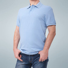 Man wearing blank blue t-shirt isolated on white background with copy space. Tshirt design and people concept - close up of men in blank shirt. For mock up template design. Front view