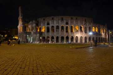 Fototapeta na wymiar Night at the Great Roman Colosseum (Coliseum, Colosseo), also known as the Flavian Amphitheatre with lights & illumination.