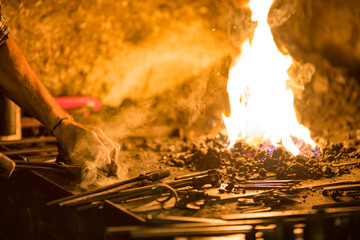 Treatment of molten metal close-up. Handmade blacksmith.