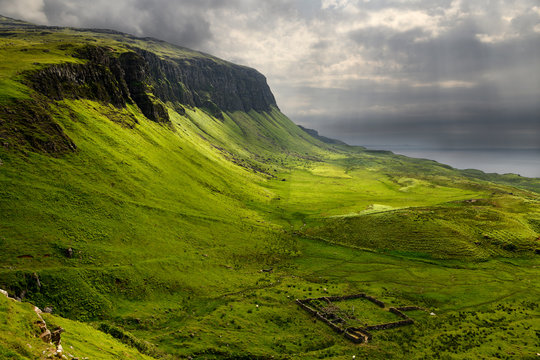 Sun Breaking Through Clouds At Balmeanach Cliffs Of Creag A Ghaill Green Slopes And Barn Ruins On Loch Na Keal Isle Of Mull Scottish Highlands