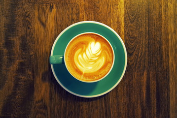 Upper view of a coffee cup on wooden table