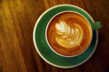 Upper view of a coffee cup on wooden table