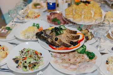 Laid festive table with food and drinks, different dishes.