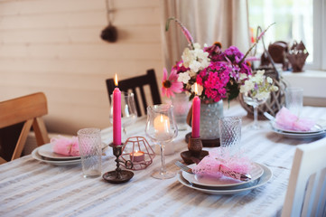 summer festive table details in pink, white and purple tones. Family romantic dinner or party in rustic country house.