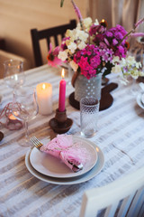 summer festive table details in pink, white and purple tones. Family romantic dinner or party in rustic country house.