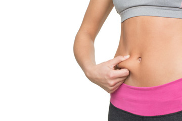 No fat here. Cropped closeup of a woman with flat tummy isolated on white copyspace on the side