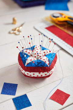 Pin Cushion Stylized Elements Of American Flag, Stacks Of Fabrics, Quilting Accessories