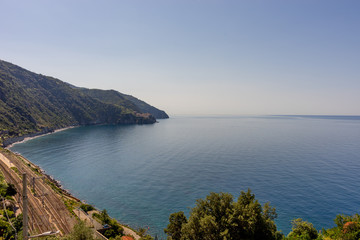 Fototapeta na wymiar Italy, Cinque Terre, Corniglia, a body of water with a mountain in the background