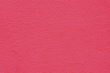 Background of a yellow pink coated and painted exterior, rough cast of cement and concrete wall texture