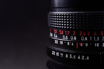 Vintage lens scale signs closeup. Stock photo with blurred gray background.