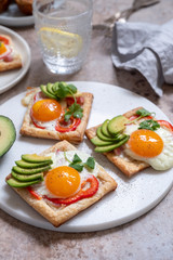 Fototapeta na wymiar Baked puff pastry with fried egg, pepper and avocado