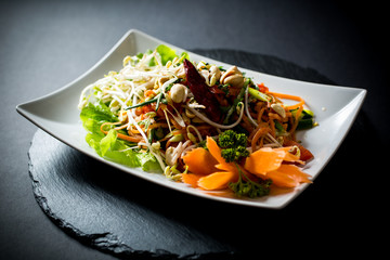 Papaya salad (Som Tam) , Thai food. Four essential flavors of Thailand. Sour, sweet, spicy and exotic. Served with homemade chili sauce.