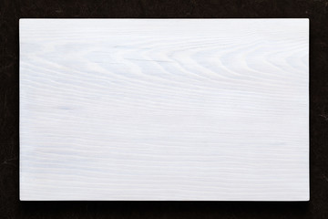 White wooden board on hand smeared burlap