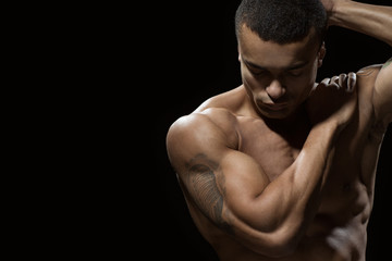 Balanced within. Portrait of an attractive fit male posing on black background copyspace on the side