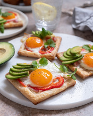 Baked puff pastry with fried egg, pepper and avocado