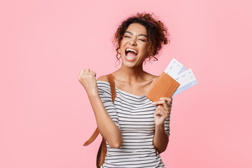 Overjoyed woman with tickets screaming, clenching fist like winner