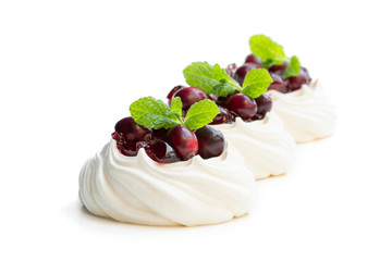 Pavlova meringue cake with cranberry and mint leaves