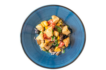 vegetarian salad of vegetables, herbs and crackers, on a blue plate