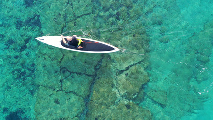 Aerial photo of man with his sup paddle board in coast of caribbean clear sandy seascape