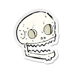 retro distressed sticker of a cartoon spooky skull