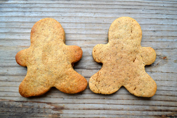 Gingerbread cookies in shape of man on wooden table