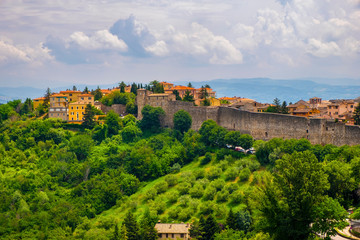 Fototapeta na wymiar Perugia, Italy - Panoramic view of the Perugia historic quarter with medieval houses and defense walls and surrounding Umbria region valleys