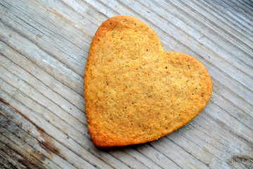 Gingerbread cookies in shape of heart on wooden table