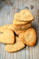 Gingerbread cookies in shape of heart on wooden table