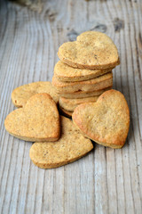 Gingerbread cookies in shape of heart on wooden table