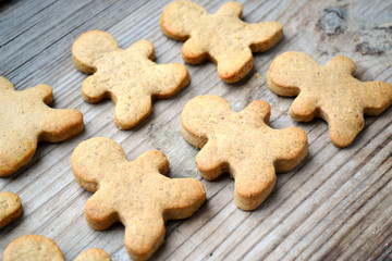 Gingerbread cookies in shape of man on wooden table