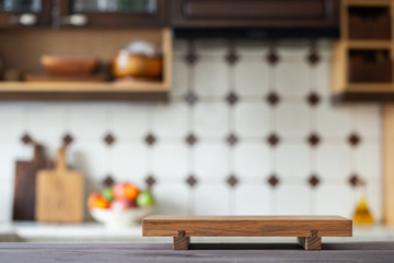 Cutting board on table over blurred home kitchen