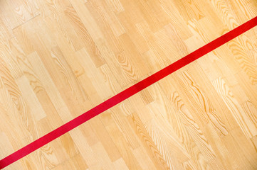 Red line on the gymnasium floor for assign sports court. Badminton, Futsal, Volleyball and...