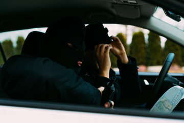 bank robbers putting their mask on prepared to do their next robbery,checking and loading their...