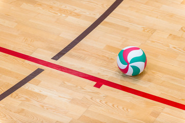 Volleyball ball on hardwood volleyball court