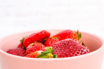 Sweet, juicy, ripe strawberries. Red, large strawberries in a pink cup. Food with vitamins. Vegetarian food.